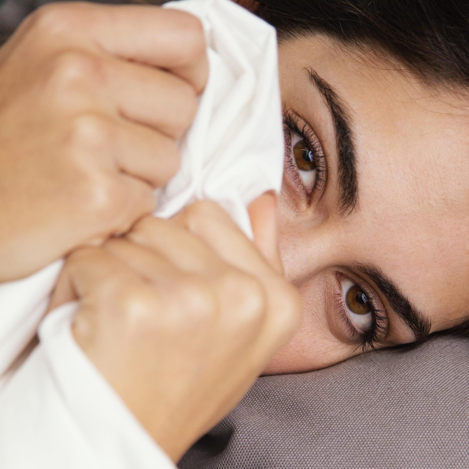 woman-hiding-sheets-home woman-hiding-sheets-home